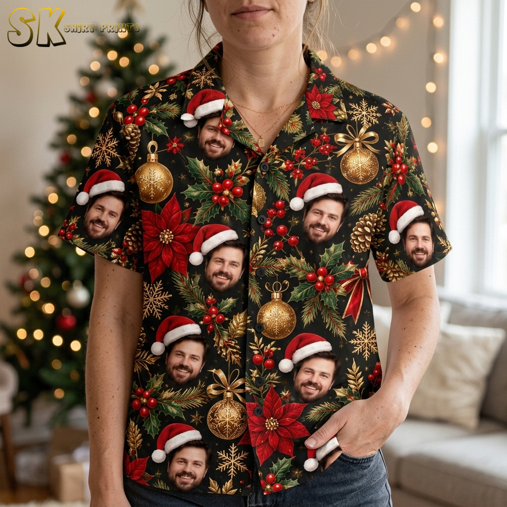 Close-up of a woman wearing a santa aloha shirt showing detailed print of Santa faces, poinsettias, holly, gold ornaments, and snowflakes on black fabric