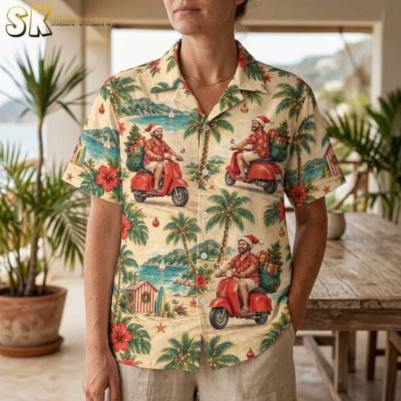 Close-up of a woman wearing a santa aloha shirt showing detailed print of Santa riding a red scooter with hibiscus flowers, palm trees, and Christmas ornaments