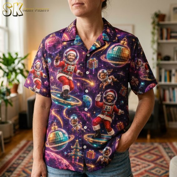 Close-up of a santa Hawaiian shirt worn by a female model showing Santa in a space suit, reindeer, planets, and disco ball motifs in purple and blue
