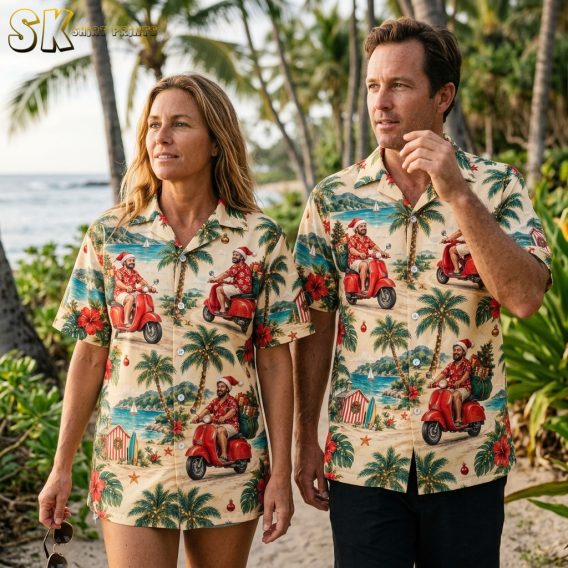 Couple wearing matching tropical Christmas shirts with Santa on a scooter, palm trees, and hibiscus flowers in a festive holiday beach theme
