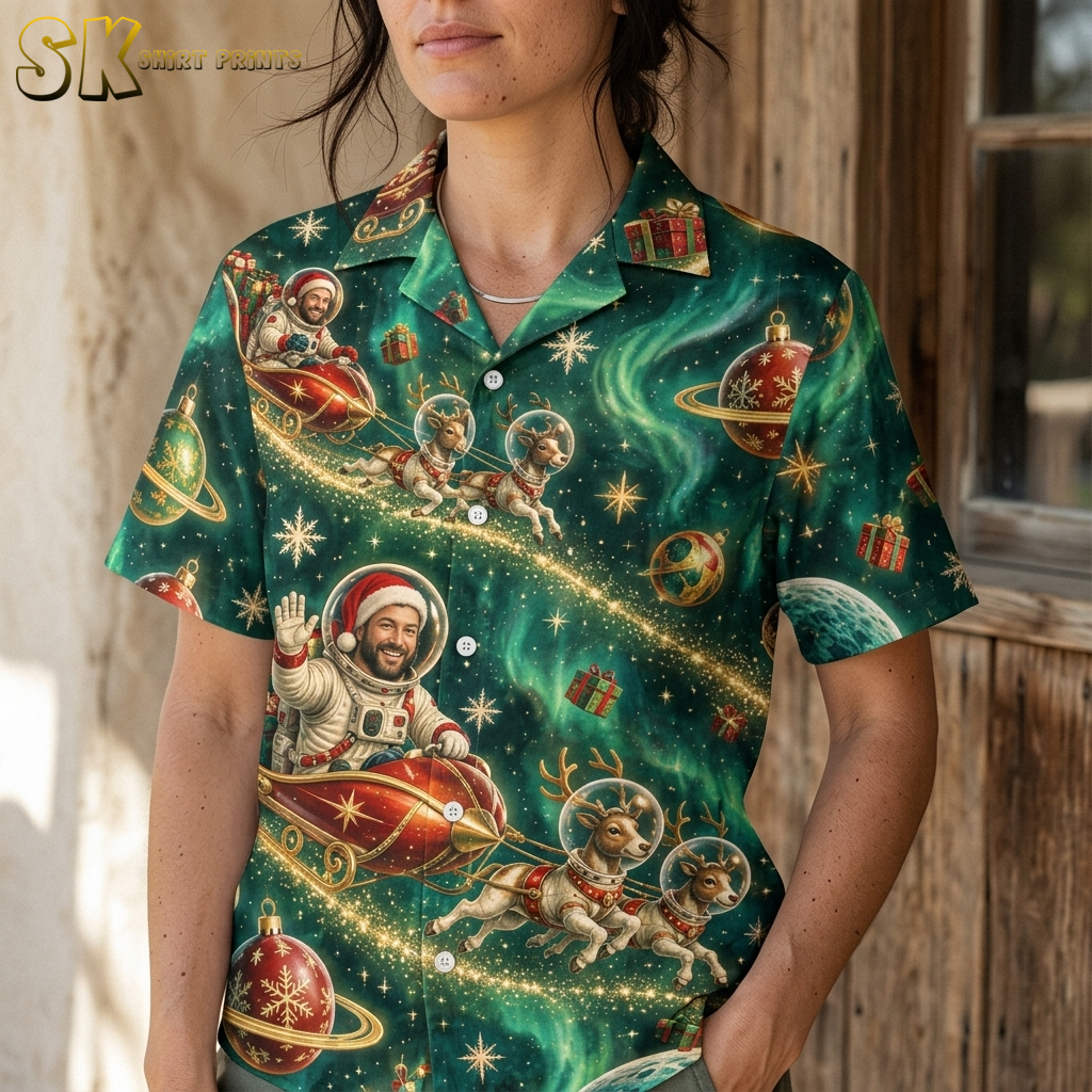 Close-up of xmas hawaiian shirt fabric on female model showing detailed Santa in spacesuit, reindeer, planets, and gift illustrations in dark green, red, and gold