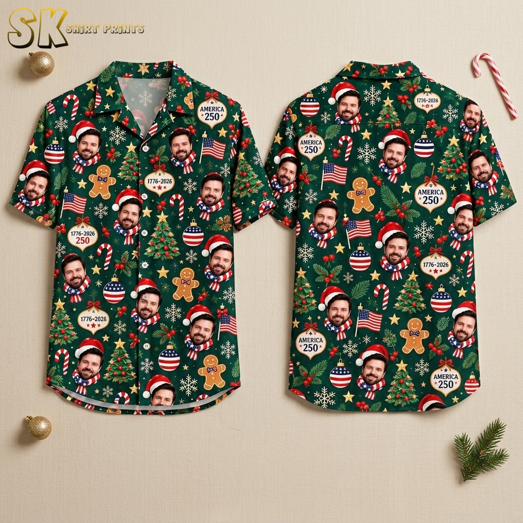 Front and back hanger view of a dark green short-sleeve button-up shirt covered in an all-over pattern of a bearded man's face in a Santa hat, decorated Christmas trees, gingerbread men, American flags, and ornaments reading AMERICA 250 with years spanning 1776 to 2026.