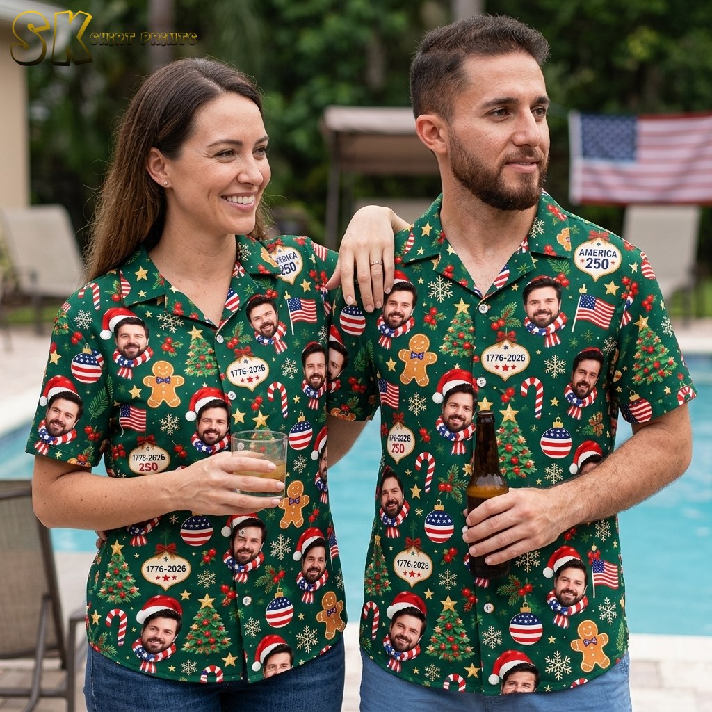 A couple shown together with one person wearing the dark green patriotic Christmas Hawaiian shirt, its pattern of photorealistic bearded faces, Christmas trees, and red-white-and-blue ornaments visible on the body.