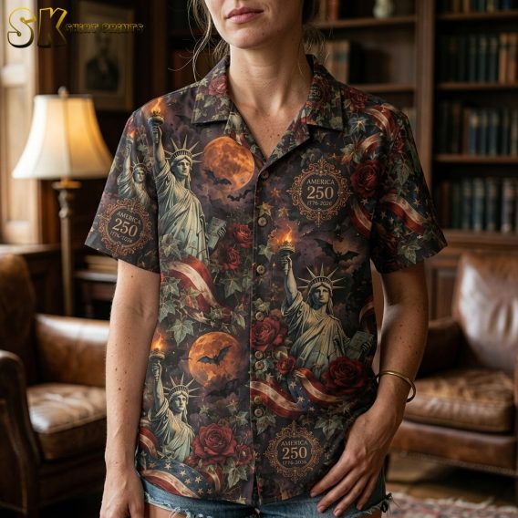 Close-up of a scary hawaiian shirt showing detailed Statue of Liberty illustration, orange moon, dark red roses, green ivy, and flying bats on a dark background.