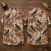Front and back hanger view of a halloween hawaiian shirt with ravens, Liberty Bells, jack-o'-lanterns, and America 250 wreaths on a beige background.