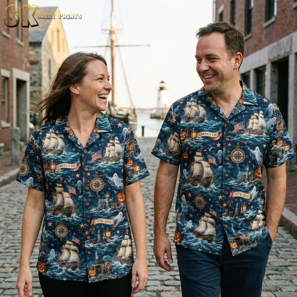 A couple shown together, with one person wearing the navy blue nautical Halloween aloha shirt featuring sailing ships, ghost figures, and carved pumpkins in an all-over print.