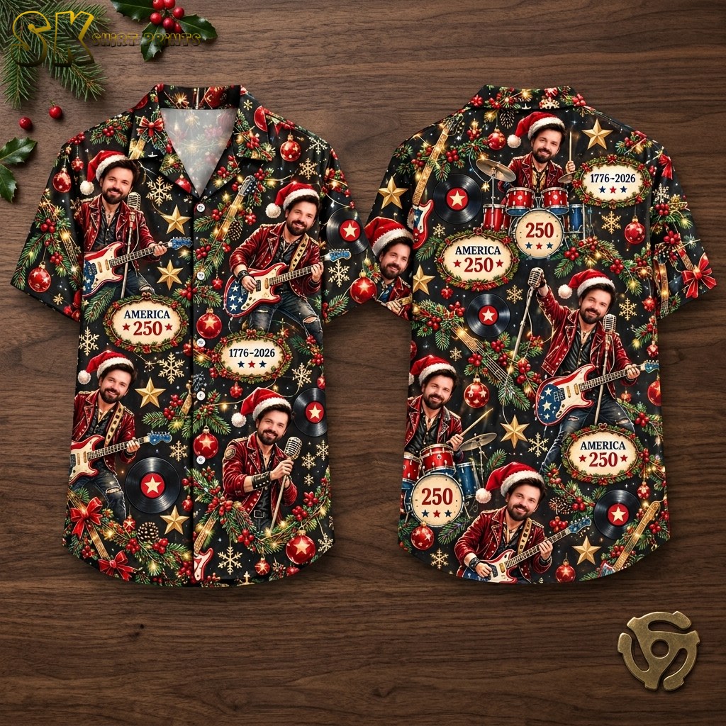 Front and back hanger view of a black short-sleeve button-up camp collar shirt covered in a dense all-over pattern of a man in a Santa hat playing guitar or drums, with Christmas ornaments, holly, snowflakes, and repeated text reading AMERICA 250 and 1776-2026.