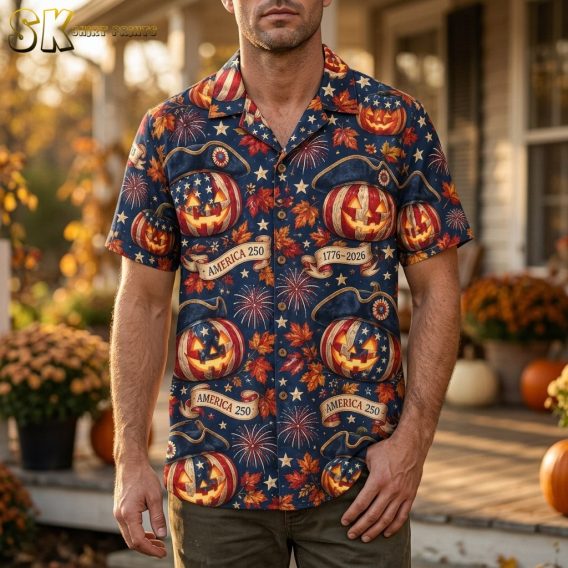 A man wearing the navy blue America 250 Halloween Hawaiian shirt, showing the all-over pattern of patriotic jack-o'-lanterns, tricorn hats, and fireworks in a lifestyle setting.