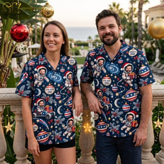 A couple shown together with at least one person wearing the navy short-sleeve button-up shirt printed with astronauts in Santa hats, holly berries, candy canes, and America 250 commemorative badges.