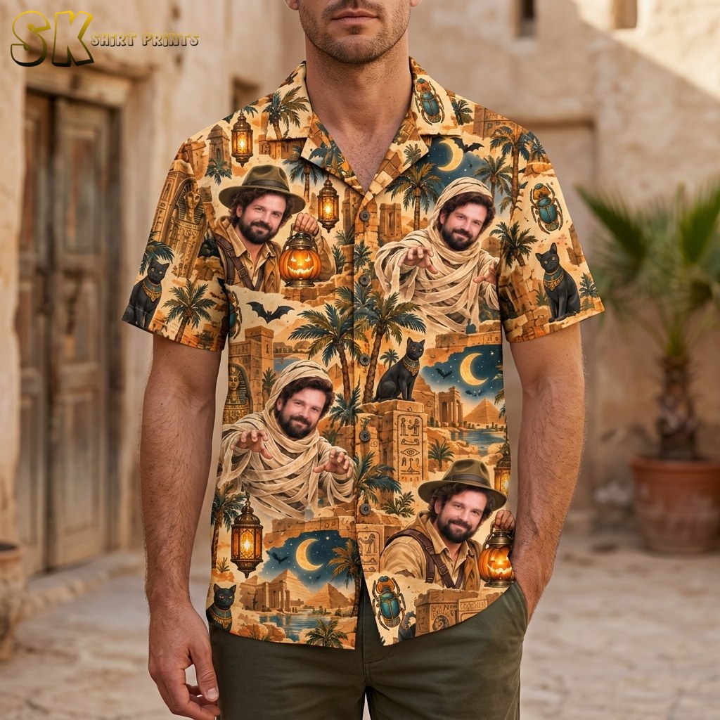 A man wearing the mens halloween hawaiian shirt stands outdoors against a stone wall, with the mummy and explorer portraits clearly visible across the chest and lower front.