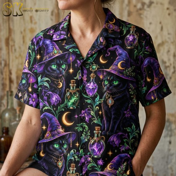 Close-up of a woman wearing a spooky hawaiian shirt showing detailed black cats with green eyes in purple witch hats, crescent moon jewelry, and glowing potion bottles.