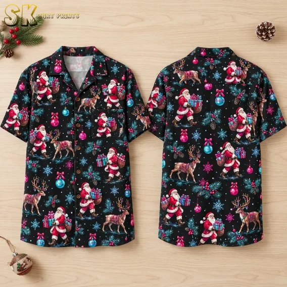 Front and back of a black Santa Claus Hawaiian shirt laid on light wood, with reindeer and colorful Christmas ornaments.
