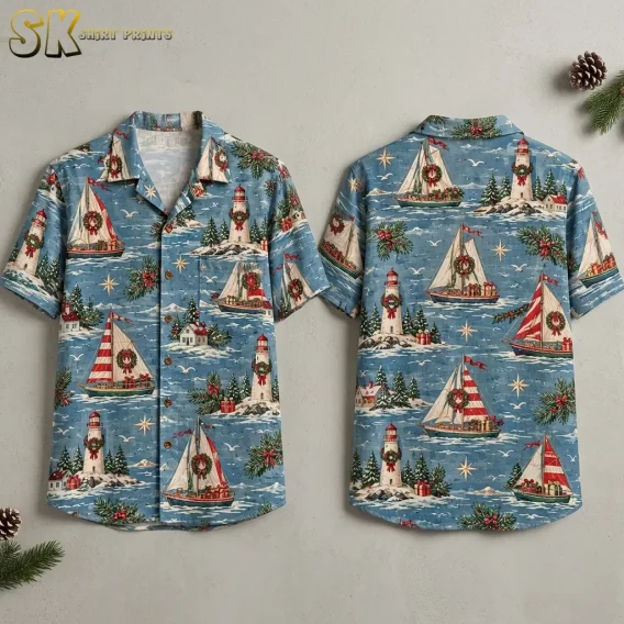 Front and back of a blue short-sleeve shirt with wreath-decorated sailboats and lighthouses, displayed against a light background.