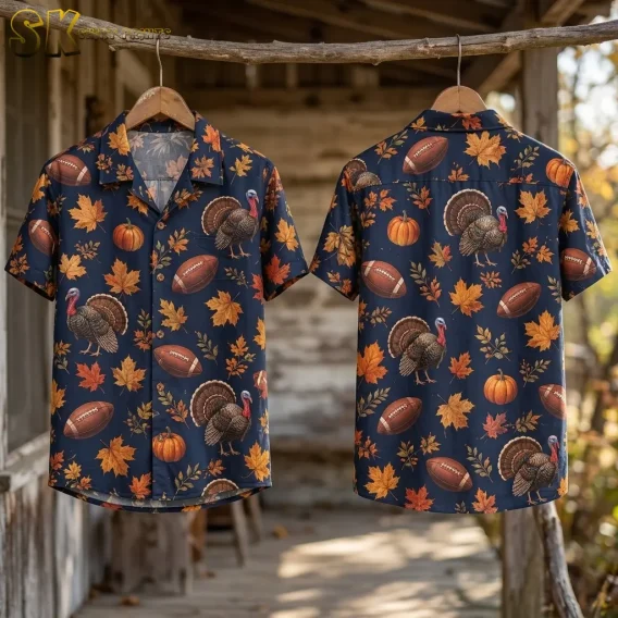 Front and back displays of a navy Thanksgiving shirt hang from a branch on wooden hangers against a rustic wooden backdrop.