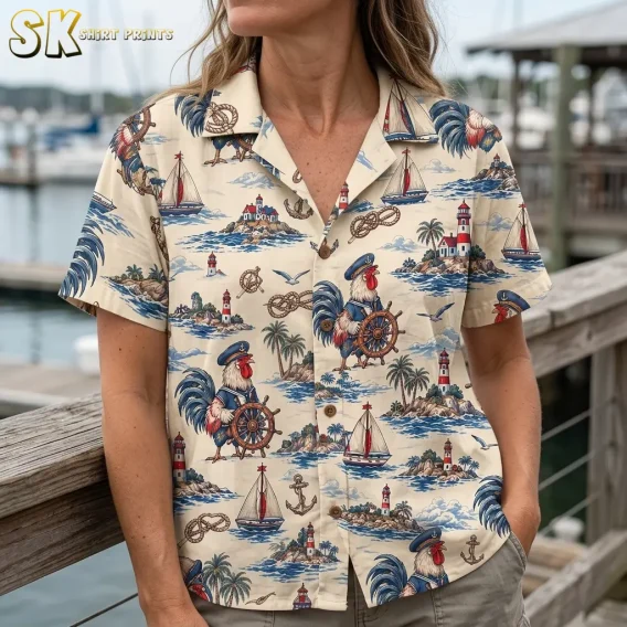 A close-up of a woman wearing the cream rooster Hawaiian shirt shows its camp collar, brown buttons, and lighthouse illustrations.