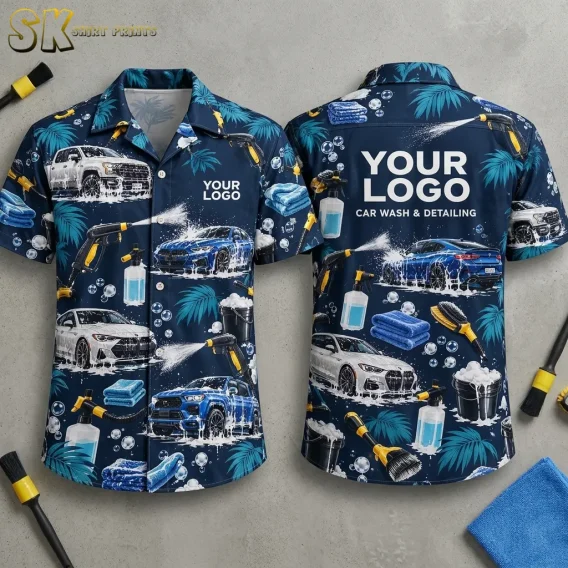 Both sides of a navy blue custom hawaiian shirt with company logo placeholder shown on a flat surface, featuring all-over car wash scenes with soap suds, spray guns, microfiber towels, and tropical palm leaves, plus 'CAR WASH & DETAILING' text across the back.