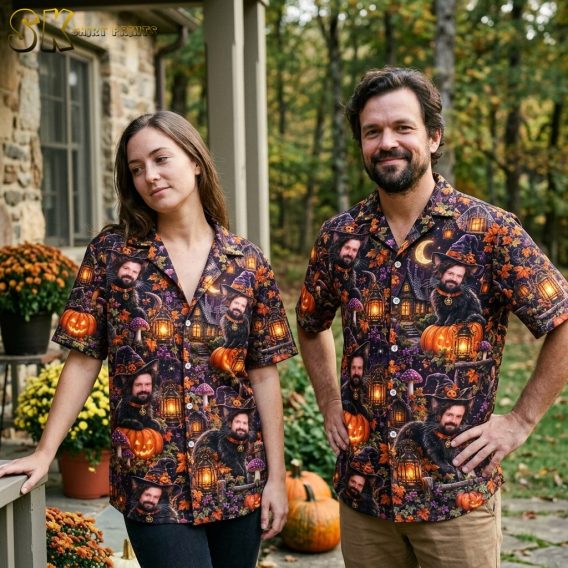 A couple shown together, with one person wearing the short-sleeve Halloween all-over print shirt featuring the cat-man figure, jack-o'-lanterns, and purple night sky motifs.