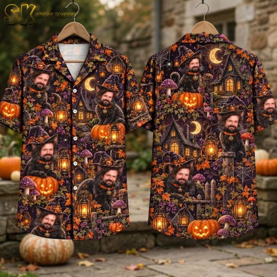Flat-lay view of the short-sleeve button-up shirt showing both the front and back laid out flat, displaying the full all-over Halloween print with jack-o'-lanterns, crescent moons, picket fences, and the repeating cat-man figure on a dark purple background.