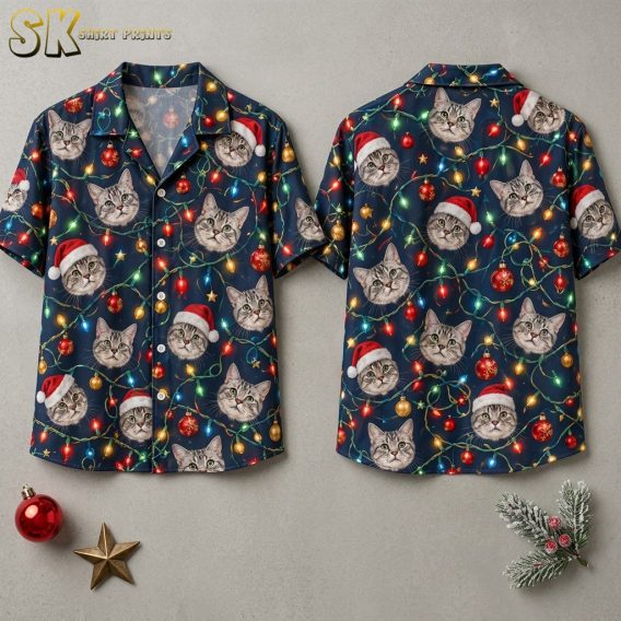 Front and back views of a dark navy christmas themed hawaiian shirt covered in realistic cat faces wearing Santa hats, multicolored string lights, and red and gold Christmas baubles, displayed flat against a light gray background.