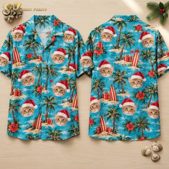 Front and back of a turquoise xmas Hawaiian shirt laid flat, showing photorealistic orange cat faces in Santa hats scattered across a tropical island scene with palm trees, hibiscus flowers, and striped surfboards.