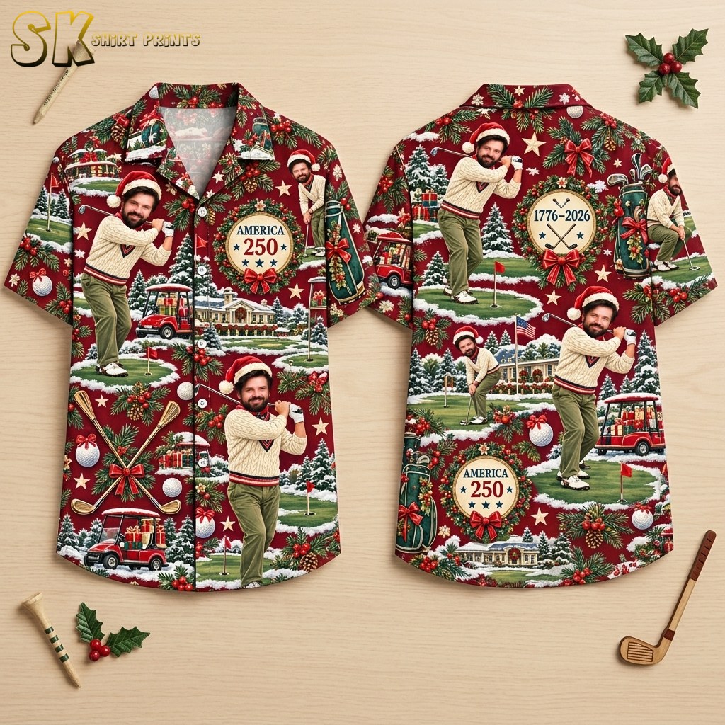 Front and back views of a deep red short-sleeve button-up shirt displayed on a hanger, covered in an all-over pattern of a man in a Santa hat golfing, golf carts, holiday greenery, and text reading America 250 and 1776-2026.