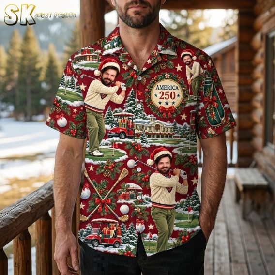 A man wearing the deep red short-sleeve button-up shirt featuring a repeating pattern of a Santa-hat-wearing golfer, golf bags, and holiday decorations.