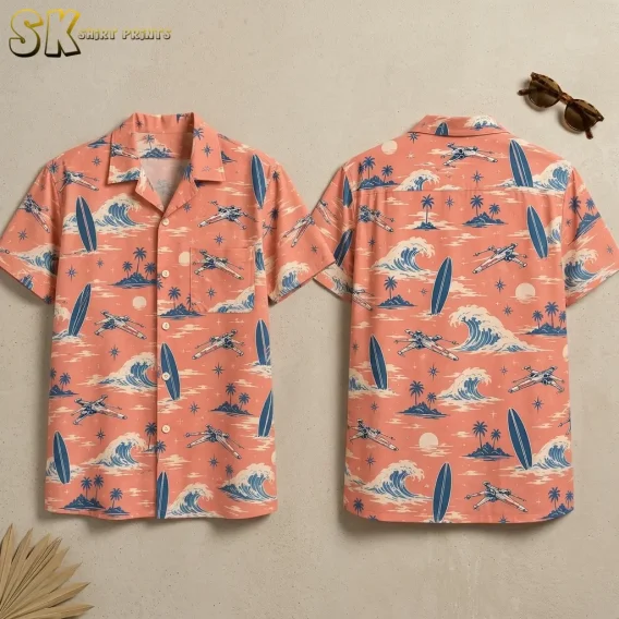 Front and back of a coral pink Star Wars Hawaiian shirt display blue surfboards, curling waves, and spacecraft on a beige surface.
