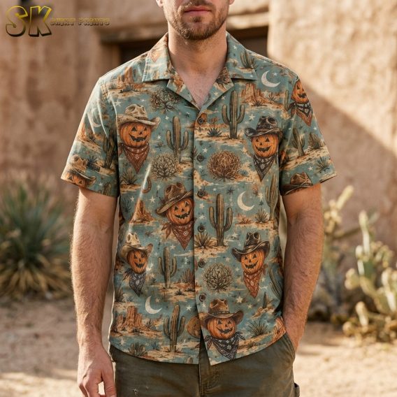A man wearing a light blue short-sleeve Hawaiian shirt featuring smiling jack-o'-lanterns in cowboy hats and bandanas scattered across a desert-themed pattern with cacti and horseshoes.
