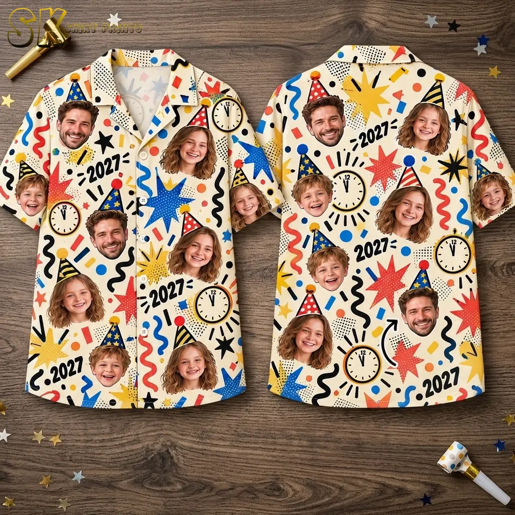 Front and back of a cream button-up shirt laid on wood, showing party-hat portraits, colorful graphics, clocks, and 2027 numerals.