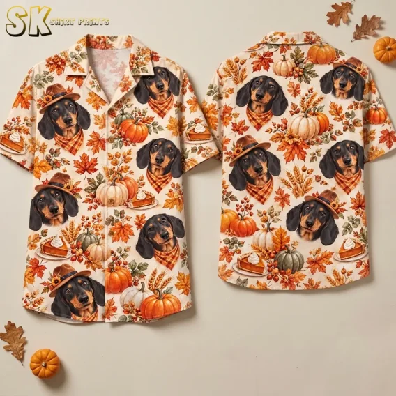 Front and back of a cream Thanksgiving button up shirt with dachshund portraits and autumn motifs, displayed beside small pumpkins and dried leaves.