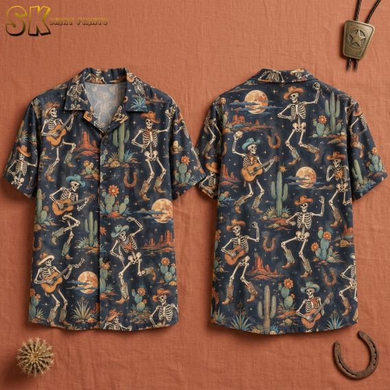 Front and back hanger view of a dark navy short-sleeve button-up shirt covered in a repeating pattern of dancing skeleton cowboys wearing hats and boots, with desert cacti, horseshoes, and full moons throughout.