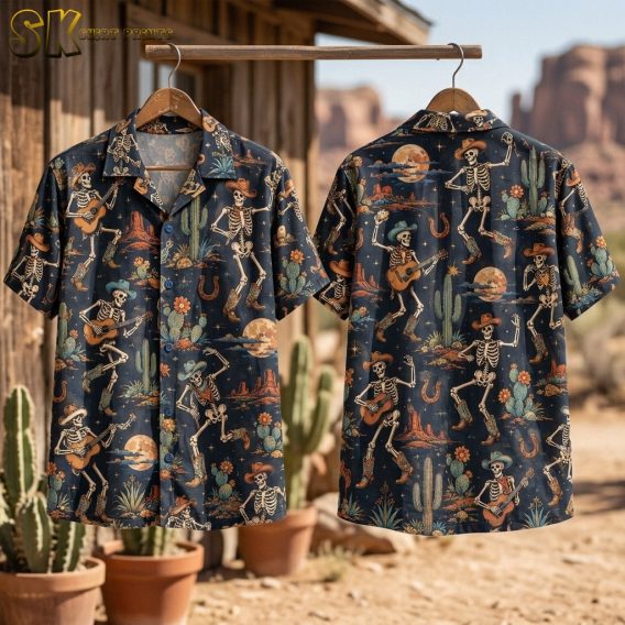 Flat-lay view of the shirt's front and back panels side by side on a surface, showing the full layout of the repeating skeleton cowboy pattern with saguaro cacti, horseshoes, desert flowers, and full moons on a dark navy background.