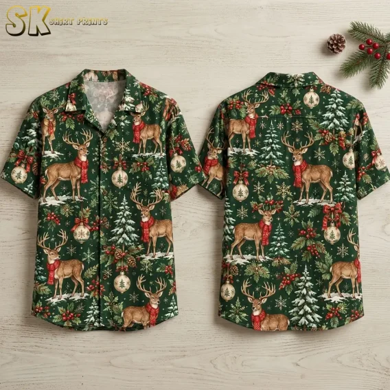 Front and back of a dark green short-sleeve shirt laid on pale wood, with scarf-wearing deer and Christmas ornaments.