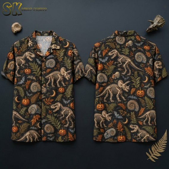 Front and back hanger views of a black short-sleeve button-up camp collar shirt printed with skeletal dinosaurs, carved jack-o'-lanterns, crescent moons, ammonite fossils, and fern leaves in beige, orange, and green on a black ground.