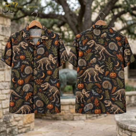 Flat lay of the black camp collar shirt showing both the front and back panels with the full repeat pattern of dinosaur skeletons, jack-o'-lanterns, crescent moons, bats, and ammonite fossils.
