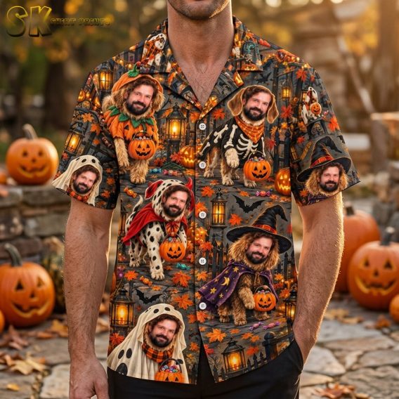 A man wearing the short-sleeve button-up Hawaiian shirt featuring bearded dogs in Halloween costumes such as a pumpkin suit, skeleton, and red devil, each holding an orange jack-o'-lantern candy bucket.