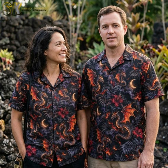 A couple shown together, with one person wearing the black dragon-print short-sleeve shirt featuring orange-winged dragons, crescent moons, and red hibiscus flowers.