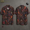 Front and back hanger view of a black short-sleeve button-up shirt printed with large orange-winged dragons breathing fire, red hibiscus flowers, crescent moons, and dark tropical palm leaves.