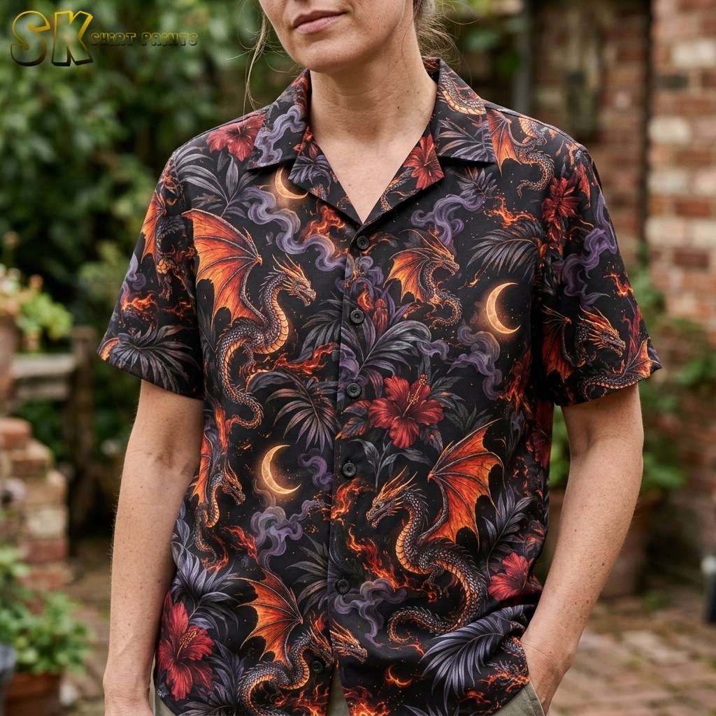 Close-up view of the dragon-print shirt on a female model, showing the detailed fantasy artwork including orange dragon wings, grey smoky swirls, and red hibiscus blossoms against the black fabric.