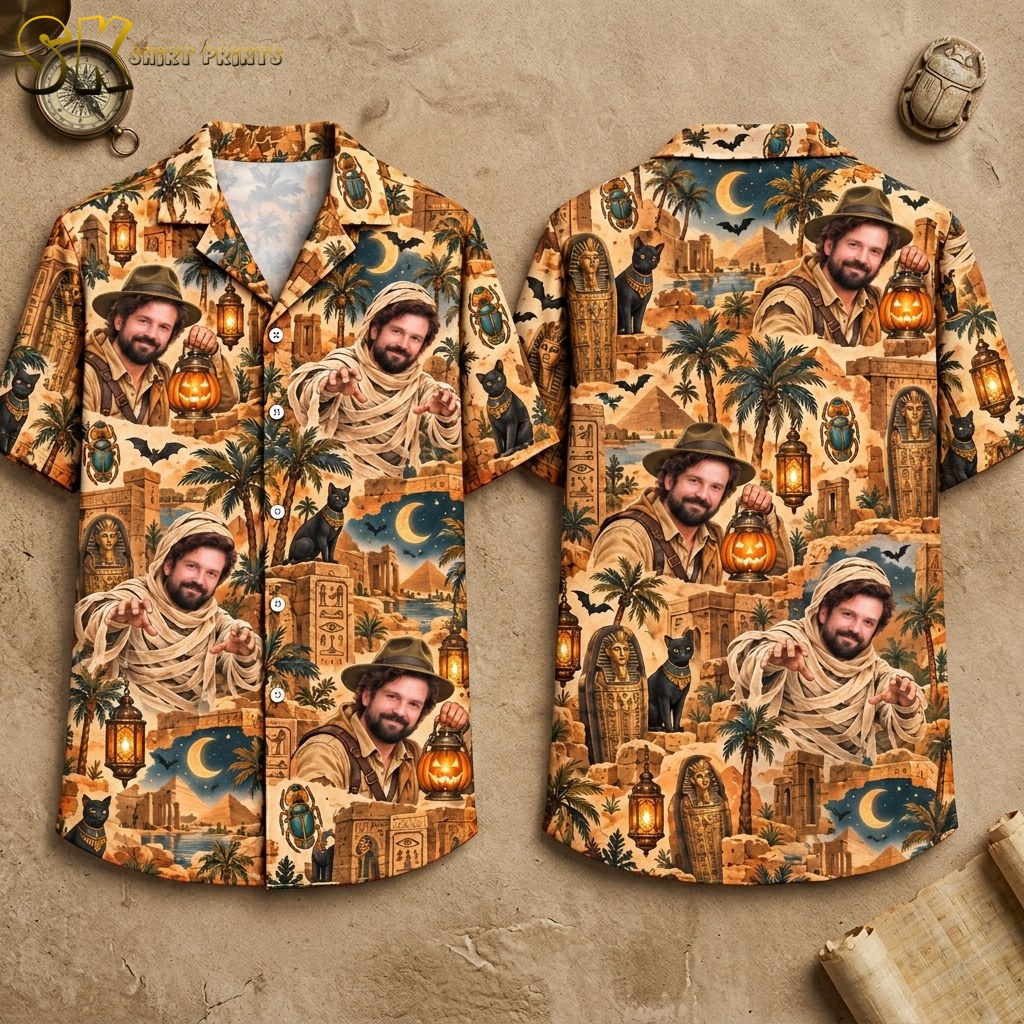 Front and back of a halloween hawaiian shirt displayed on an invisible hanger, showing repeating portraits of a bearded man as an explorer and as a mummy alongside scarab beetles, black cats, pyramids, and pumpkin lanterns on a sandy beige ground.