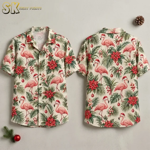 Front and back of a cream short-sleeve shirt with Santa-hat flamingos and red poinsettias against a light background.
