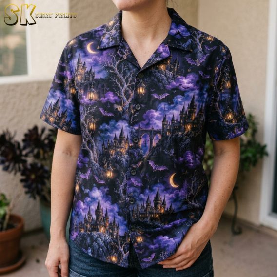 Close-up of a woman wearing a spooky hawaiian shirt, showing detailed gothic castle, bat, leafless tree, and glowing lantern artwork on a dark purple background.