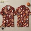 Front and back hanger views of a burgundy halloween hawaiian shirt with gingerbread houses, ghosts, witch hats, and pumpkin pie motifs.