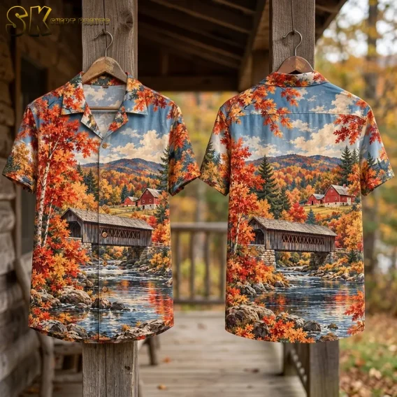Front and back displays of the autumn print shirt hang from wooden porch posts, showing a covered bridge above a reflective river.
