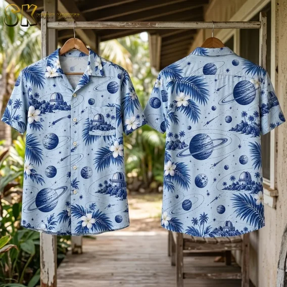 Two light blue celestial print shirts hang from wooden hangers on a porch, displaying the front and back side by side.