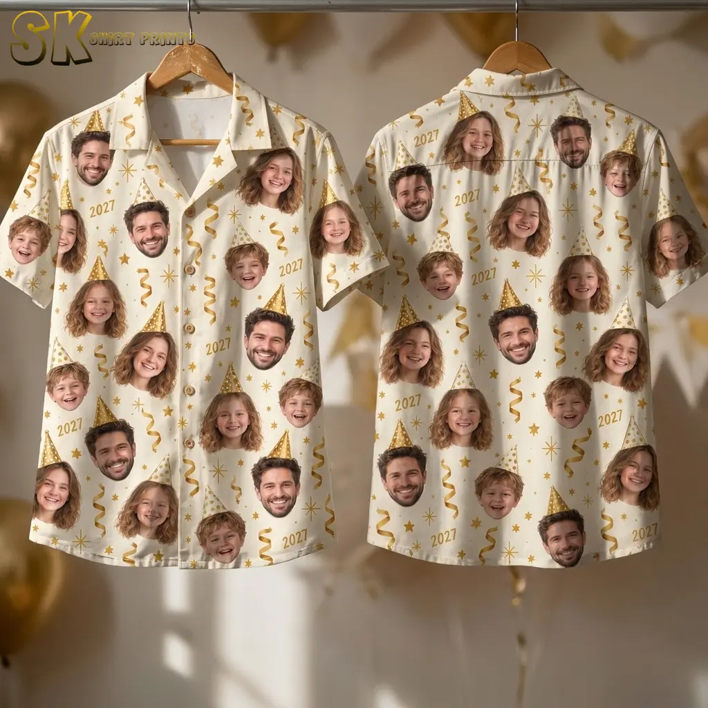Two ivory face-print shirts hang from wooden hangers, displaying the buttoned front and back with gold stars, streamers, and 2027 numbers.