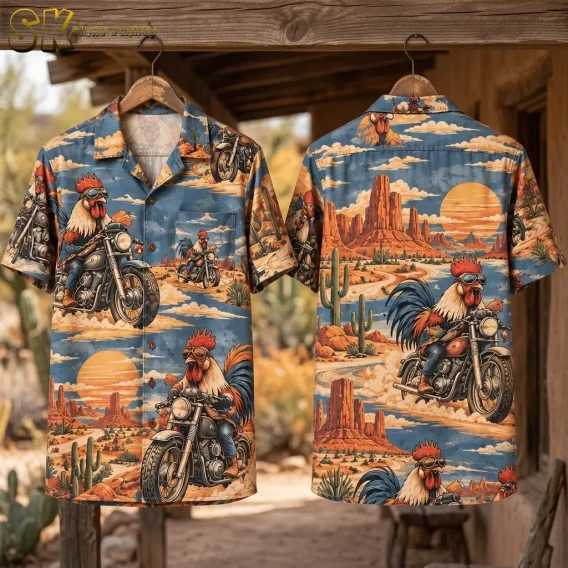 Front and back of a blue rooster Hawaiian shirt hang from a wooden beam, displaying motorcycle riders, desert rock formations, and an orange sun.