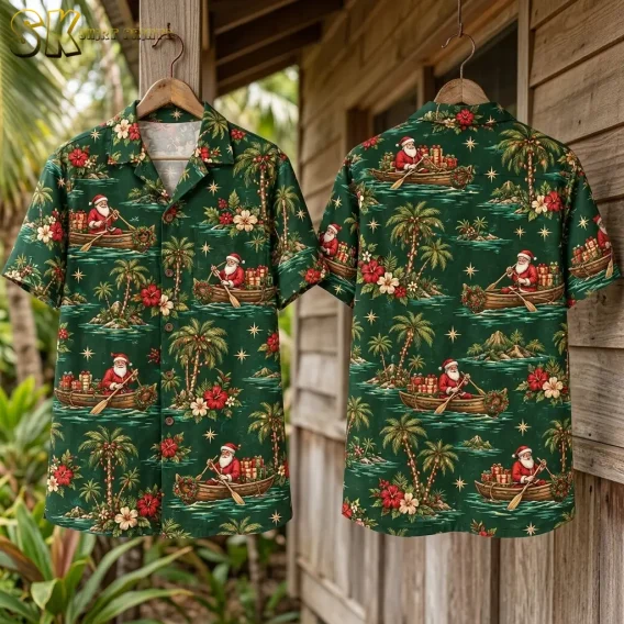 Front and back displays of a green Hawaiian shirt with Santa Claus hang from wooden hangers beside a wooden wall.