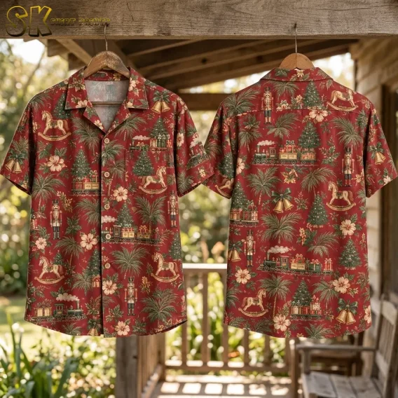 Front and back of the shirt hang side by side on wooden hangers on a rustic porch, with the Christmas tree and toy-train motifs on the front and the nutcracker and rocking-horse arrangement on the back both clearly visible.