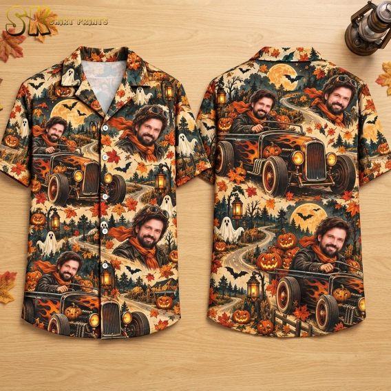 Front and back hanger view of a beige short-sleeve button-up shirt covered in a repeating pattern of a bearded man driving a flame-decorated black vintage hot rod, surrounded by jack-o'-lanterns, floating ghosts, bats, and a moonlit country road.